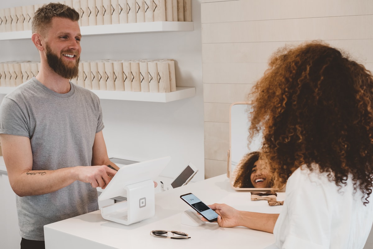 Merchant accepting a contactless mobile payment at checkout
